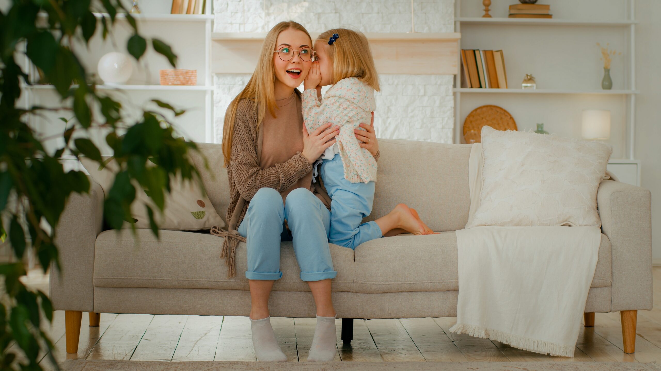 little girl telling mom a secret