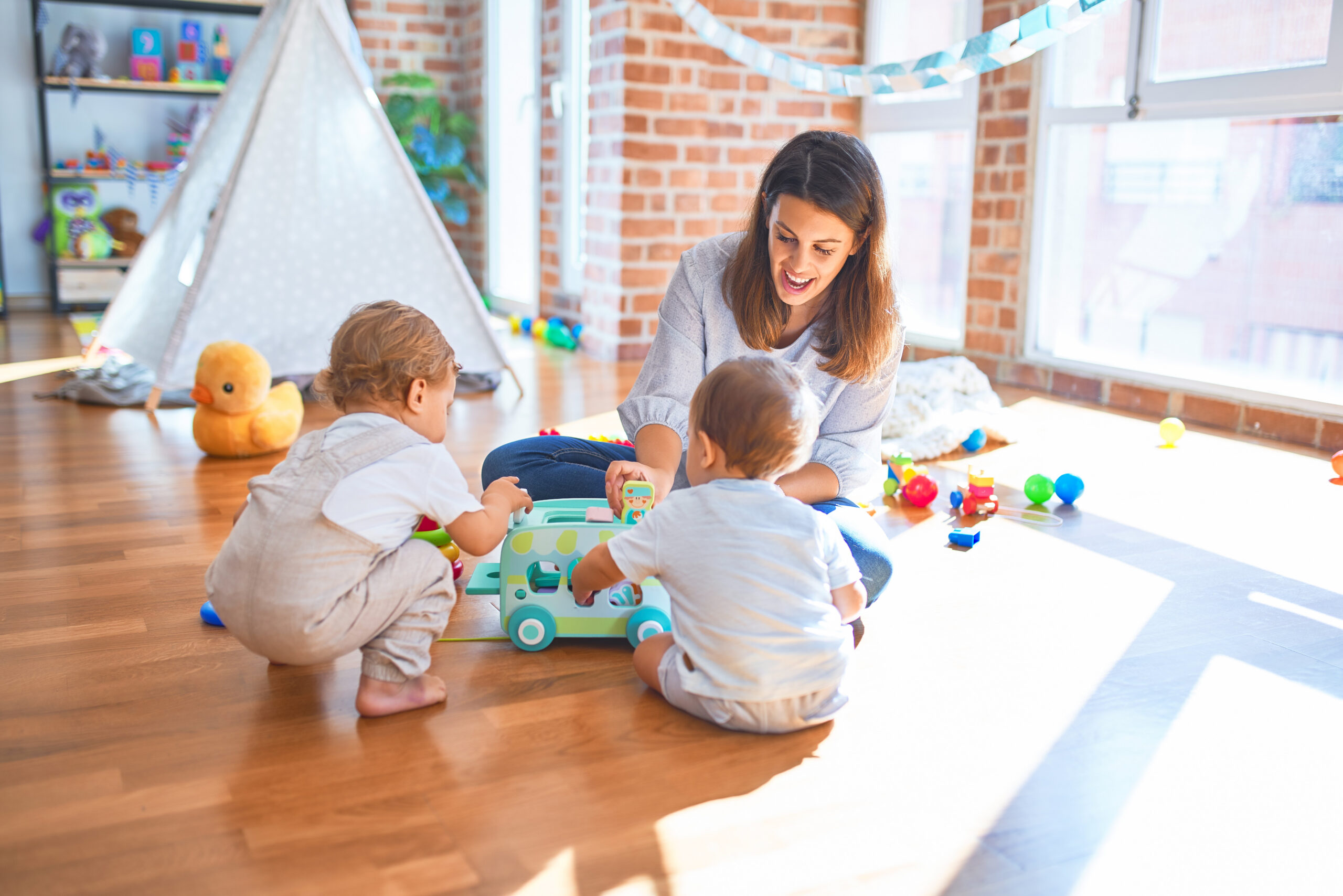 nanny playing with 2 toddlers